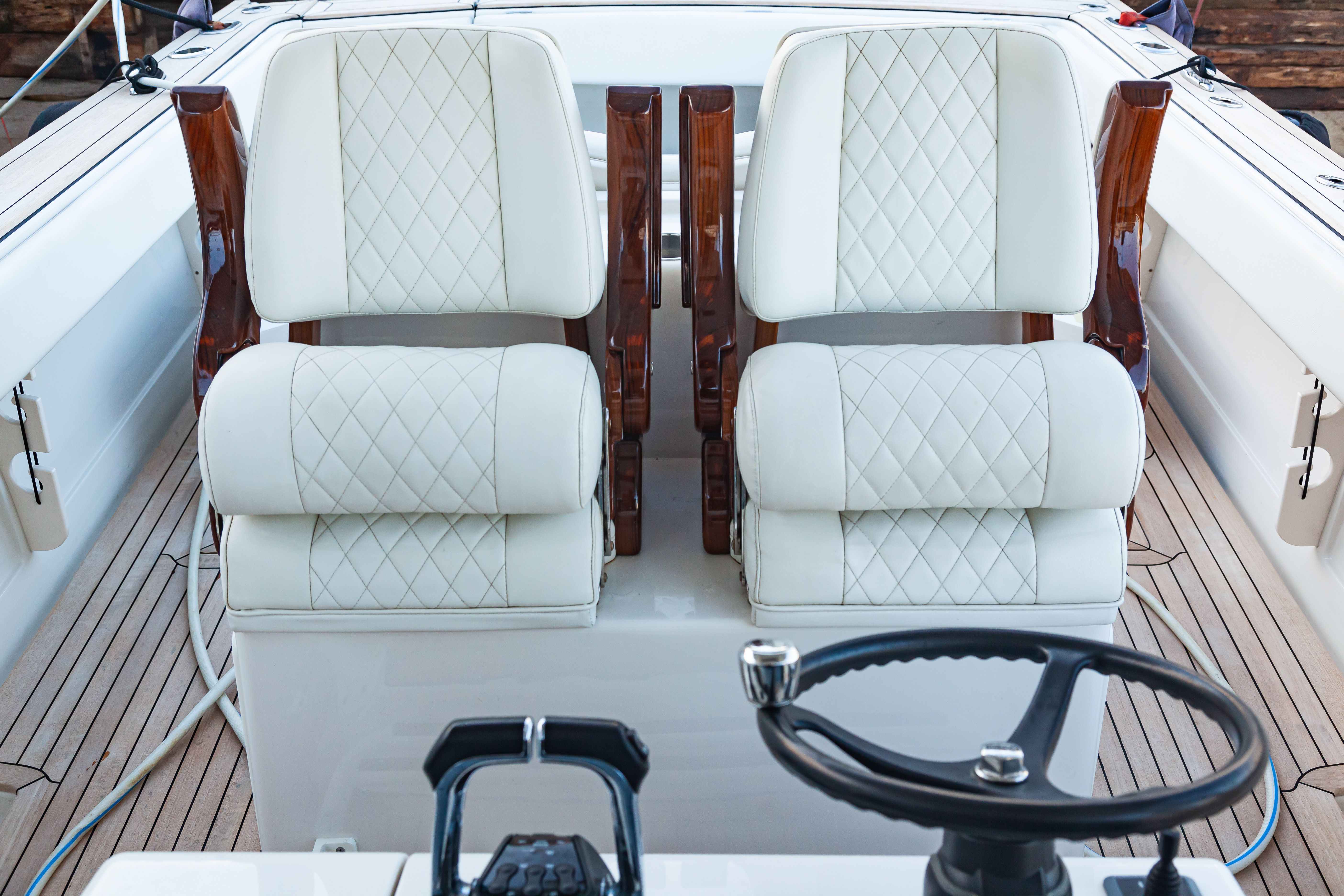 Two white leather armchairs on a luxury motor boat, close-up.