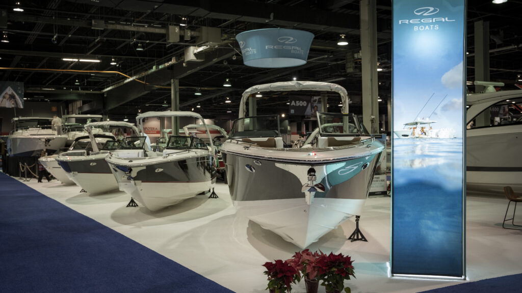 Regal Boats display lineup at the Chicago Boat Show featuring luxury bowriders under bright showroom lights